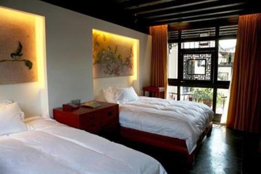 фото отеля Lijiang Zheng Fu Cao Tang Inn Shu Xiang Mansion