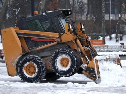Excavator clears snow on the streets of Kiev, Ukraine