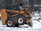 Украина в блокаде из-за циклона, принесшего ледяной дождь и снег - Excavator clears snow on the streets of Kiev, Ukraine